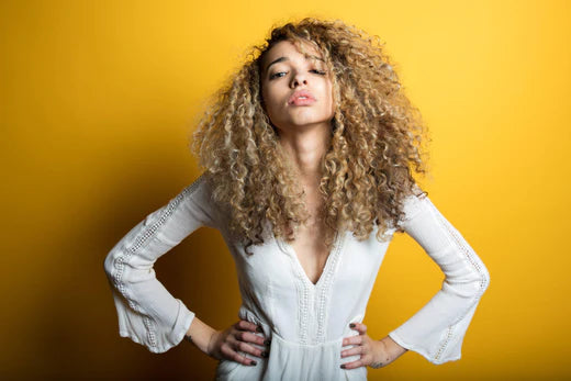a woman with curly hair posing for a picture