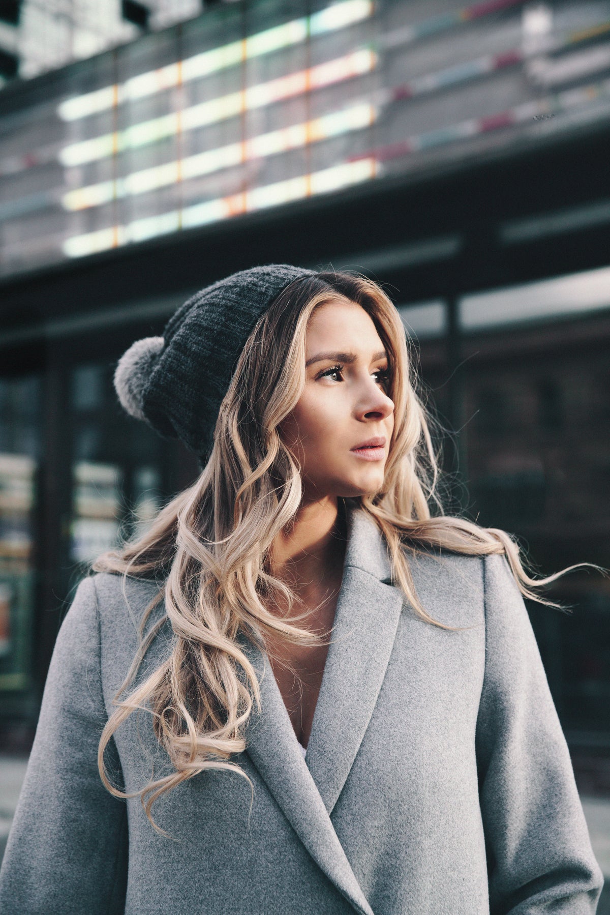 a woman in a grey coat and hat
