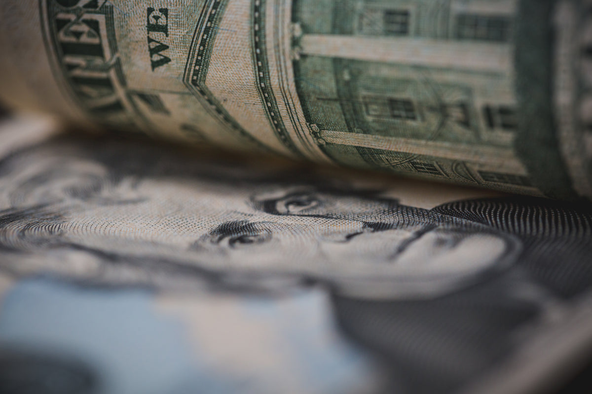 a close up of a rolled up dollar bill